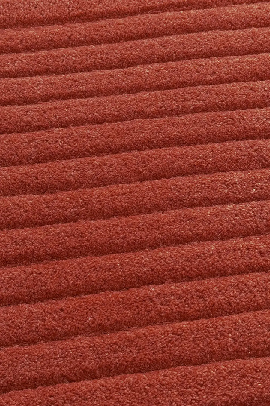 Close-up of the Ridge Duo Rug's textured ridges in terracotta 