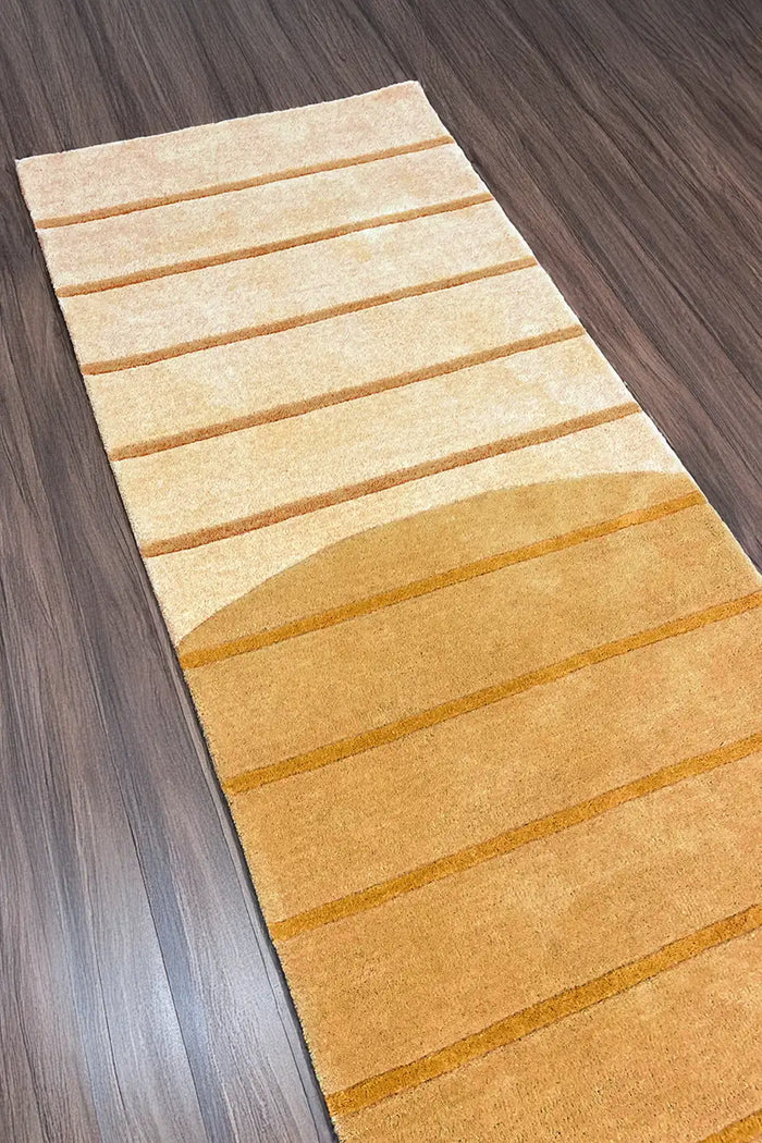 Golden striped long wool runner rug in a modern hallway setting, highlighting its bold color and hand-tufted texture