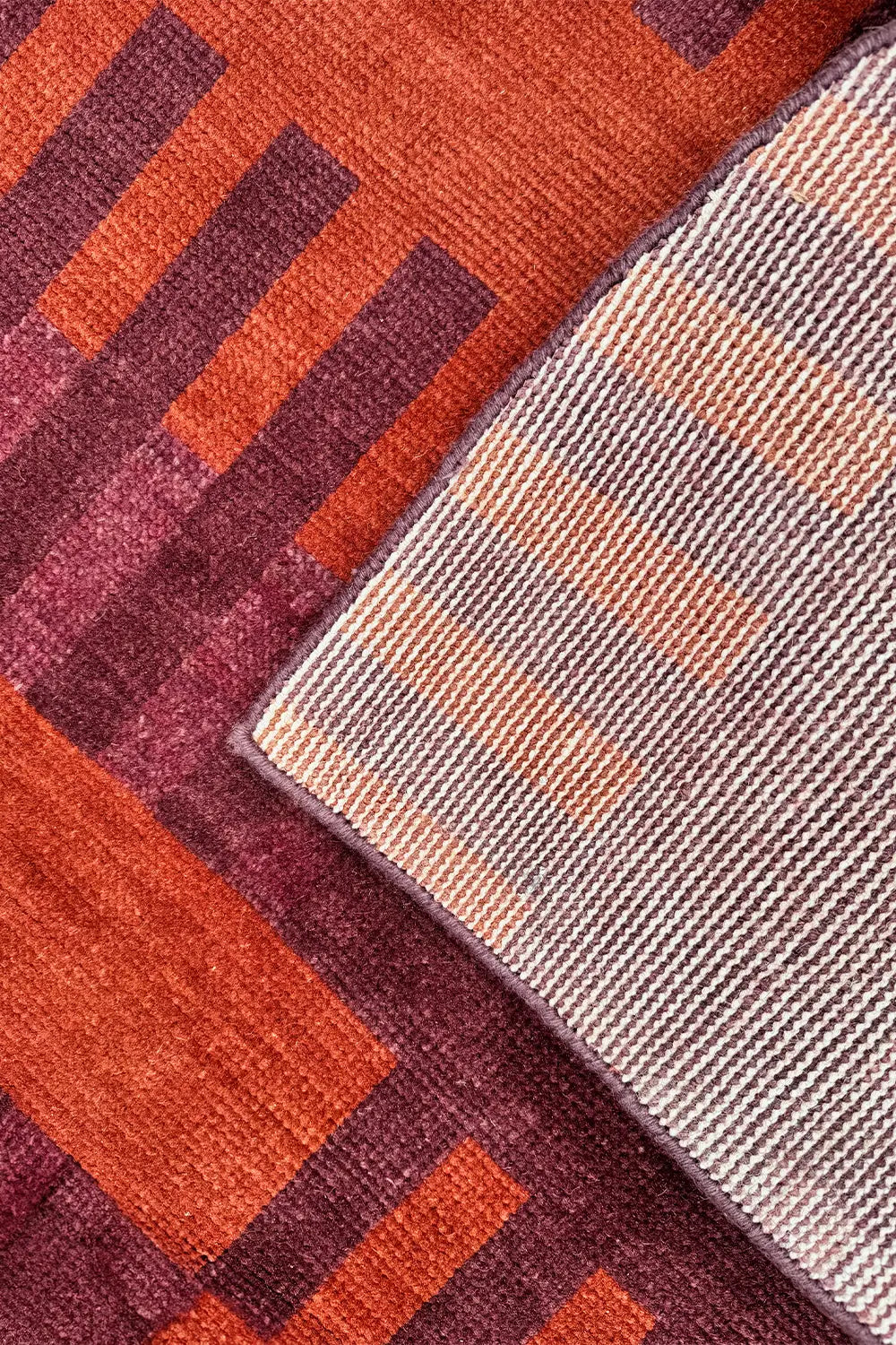 Deep red and brick-colored area rug hand-knotted in a traditional Oushak design