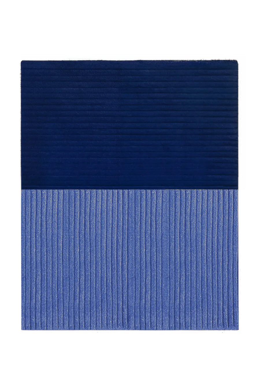 Hand-tufted wool rug in navy blue and light blue, perfect for styling a modern living room