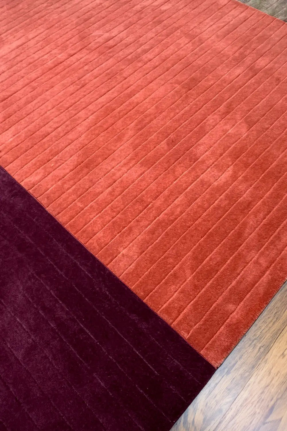 Two-tone textured rug in burgundy and rust burnt orange, perfect for boho-inspired decor
