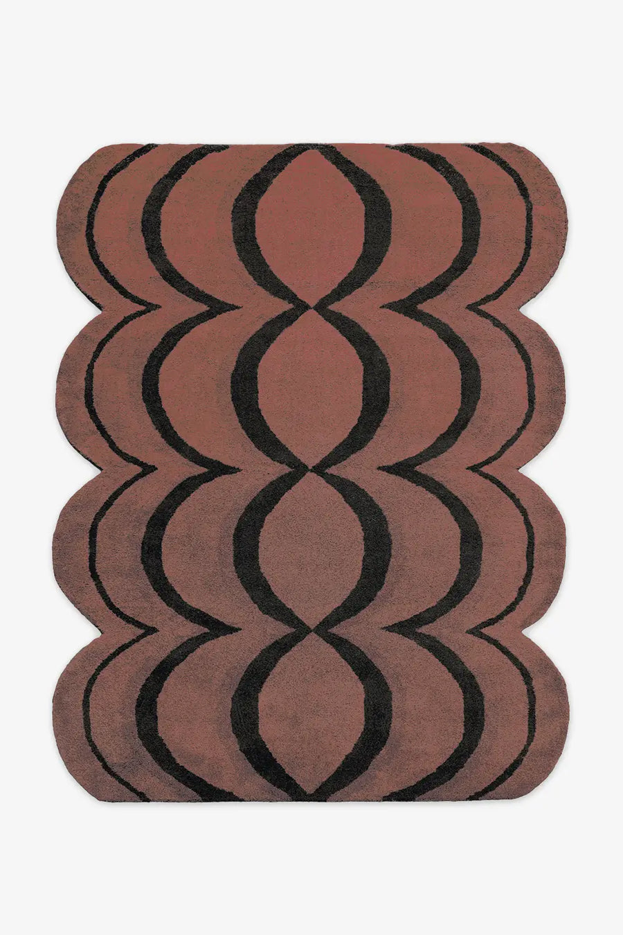 brown and black irregular shaped tufted wool rug with scalloped edges perfect for funky and southwestern interiors