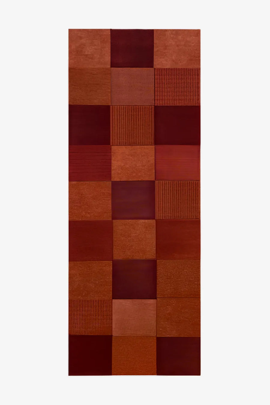 Terracotta wool runner rug with a modern geometric block pattern.
