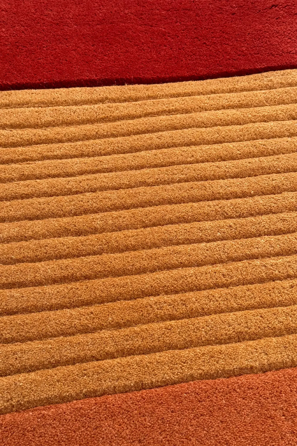 close-up of textured mustard yellow and rust rug perfect for mid century modern living rooms