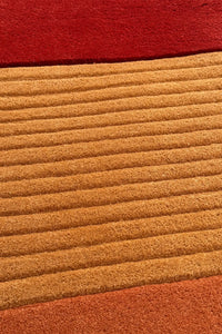 close-up of textured mustard yellow and rust rug perfect for mid century modern living rooms