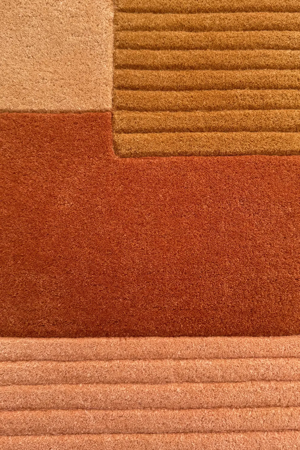 Hand-tufted oval wool rug in soft neutral earth tones.
