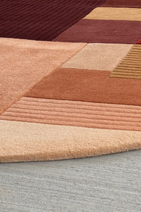Close-up of 4x6 arched wool rug with neutral toned block design and soft tufted finish in terracotta and ochre