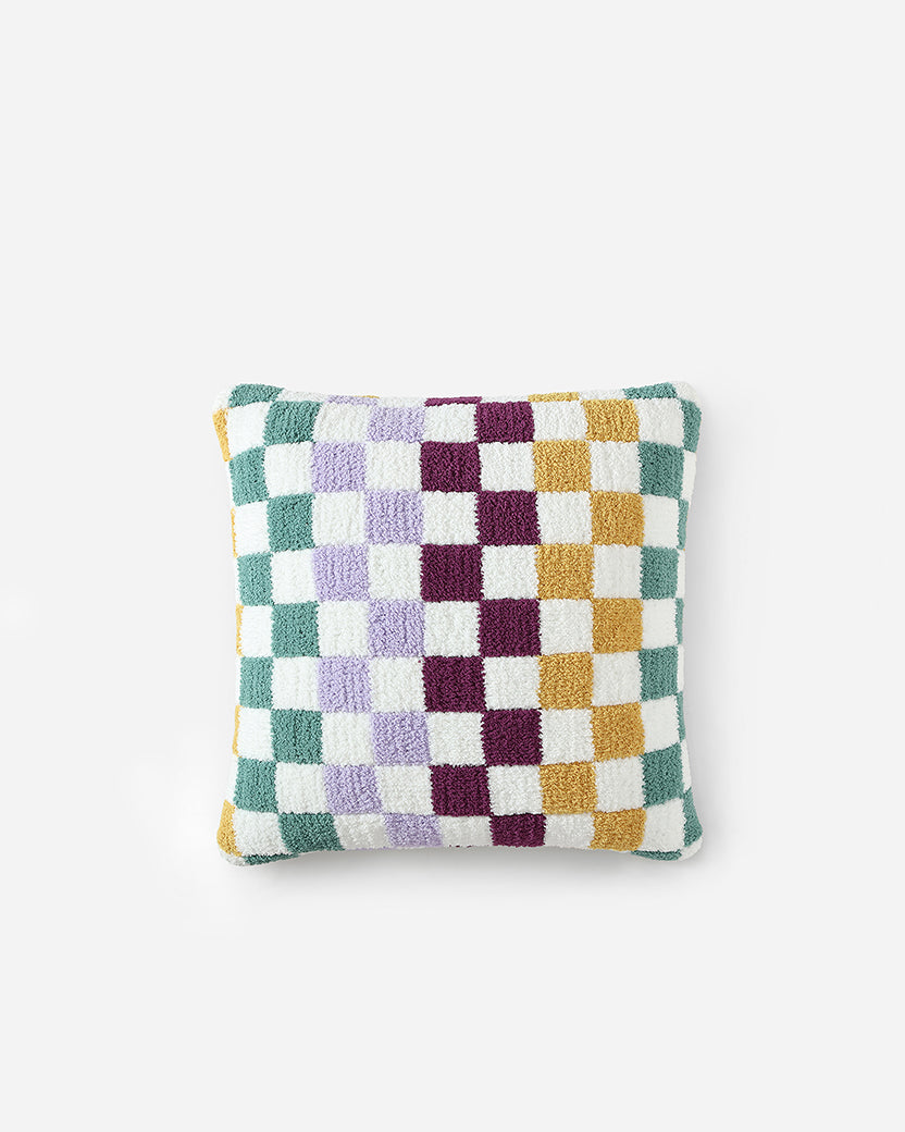 Decorative colorful checkered pillow on a couch, enhancing living room style.