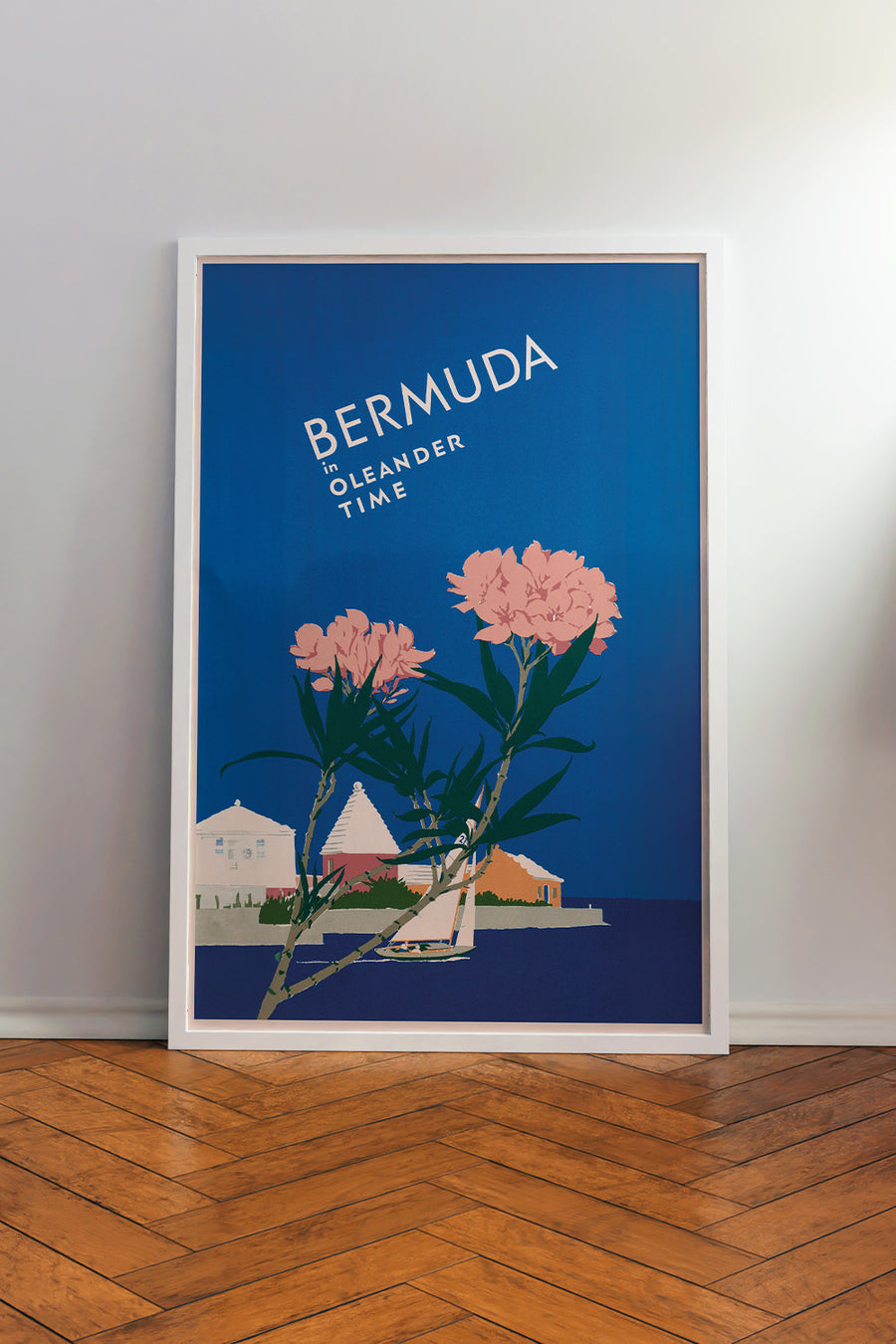 Vintage Bermuda travel poster by Adolf Treidler depicting an island with two pink oleander flowers and "Bermuda in Oleander Time" text on a blue background.