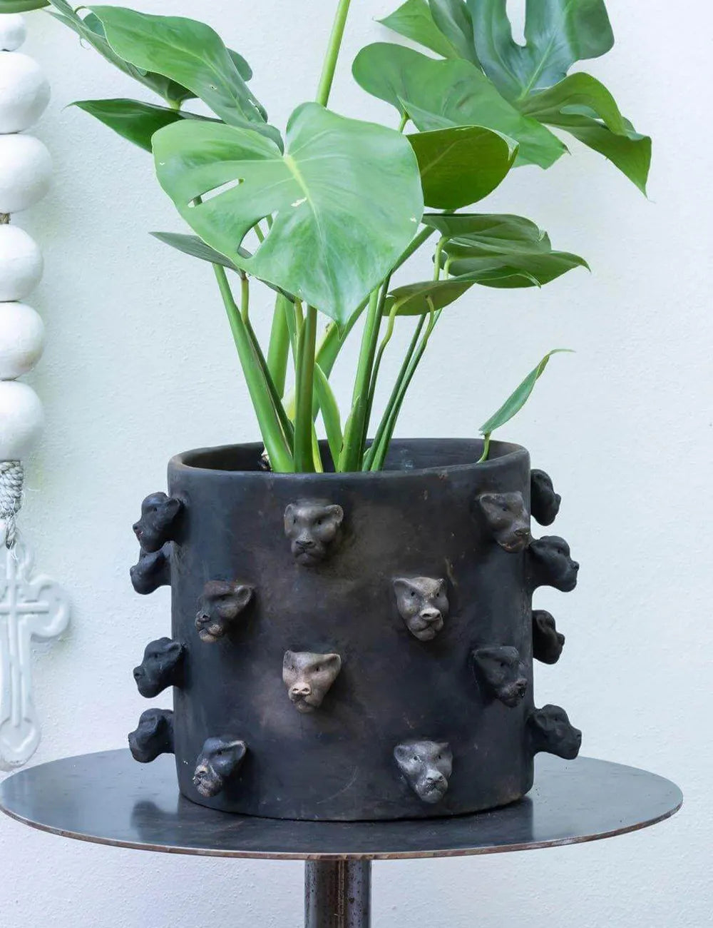 black ceramic planter with spiked jaguar heads