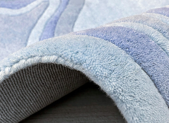Close-up of a textured blue rug with a soft finish.