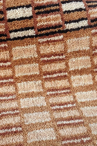 Close-up of woven wool checkerboard pattern with natural texture, perfect for luxury living rooms, dining spaces, and organic modern design
