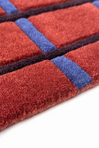 Close-up of a red and blue striped rug on a white background