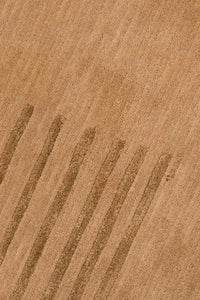 Detail of modern gold wool rug with minimalist linear design, ideal for 9x12 living rooms, dining spaces, and serene bedrooms