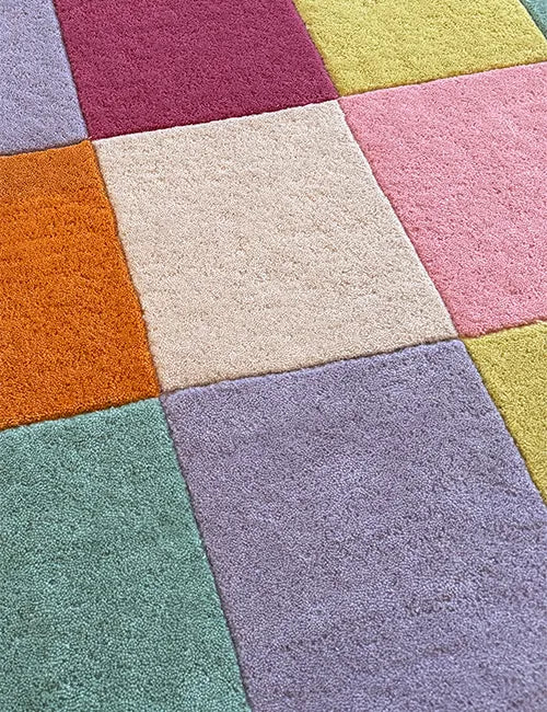 Multicolor patchwork rug close-up, modern colorful wool rug texture
