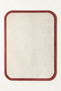a contour edge hand-tufted wool rug in brick and oat, shown flat from above