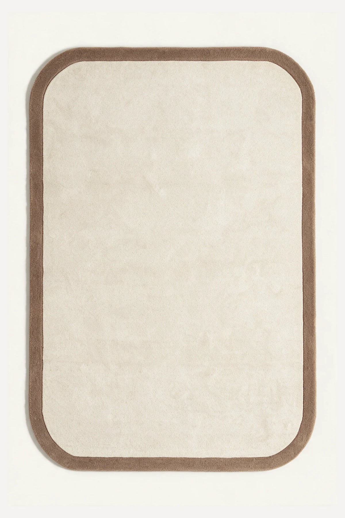 a contour edge hand-tufted wool rug in oat and mink, shown flat from above