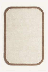 a contour edge hand-tufted wool rug in oat and mink, shown flat from above