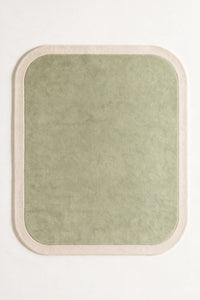 a contour edge hand-tufted wool rug with an oat border and a mist inside, shown flat from above