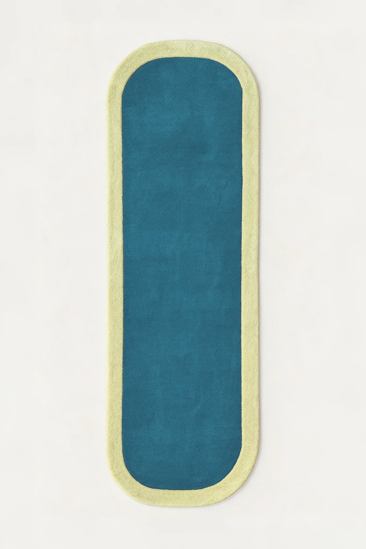 a contour edge hand-tufted wool runner in pistachio and teal, shown flat from above