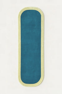 a contour edge hand-tufted wool runner in pistachio and teal, shown flat from above