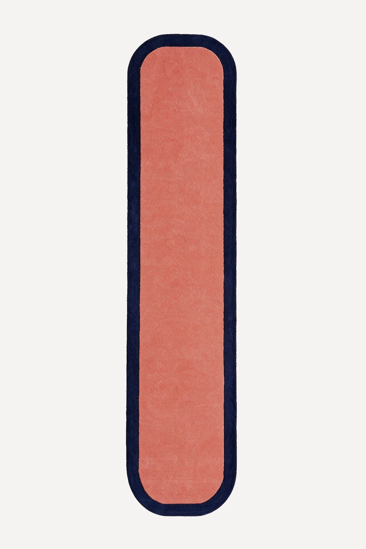 a contour edge hand-tufted wool runner in salmon and navy, shown flat from above