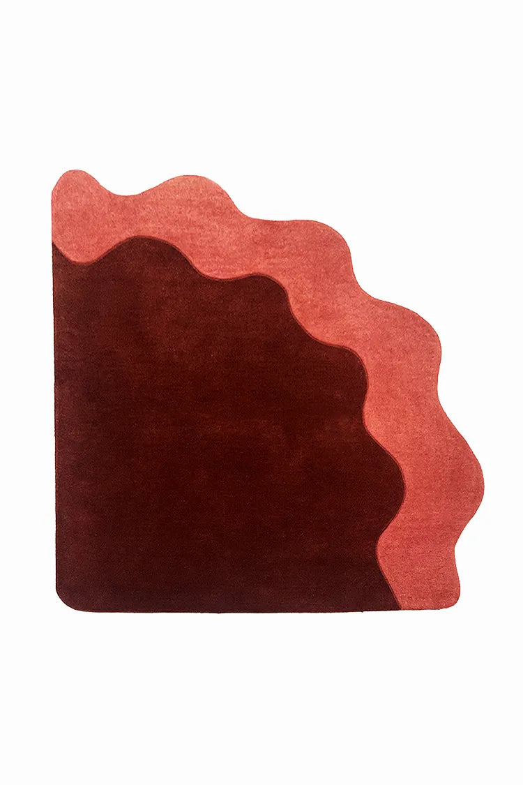 custom corner rug with wavy red and brown design on a white background