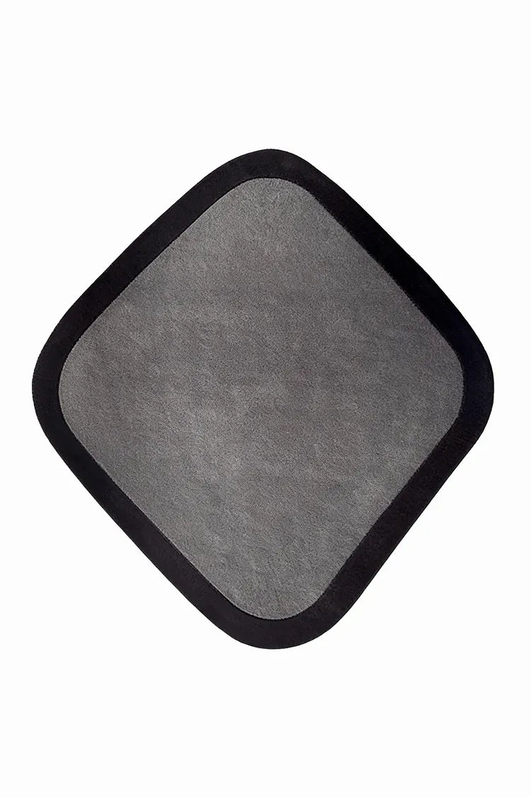 custom diamond shaped rug with black border on a white background