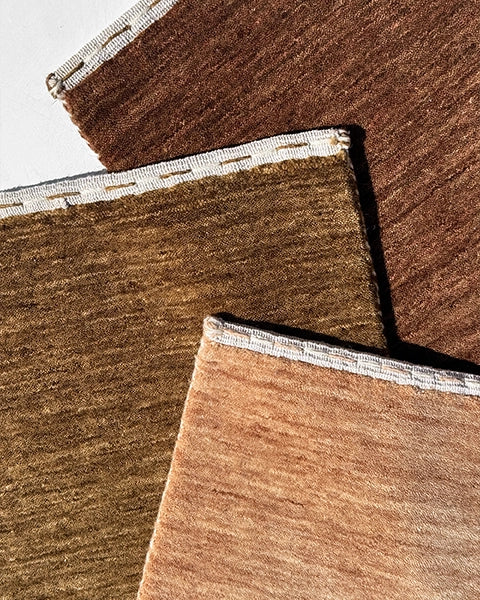 earth tone wool rugs in brown, tan, and ochre