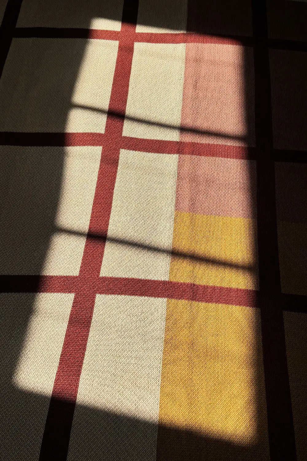 Soft, breathable organic cotton throw blanket with a timeless plaid pattern.
