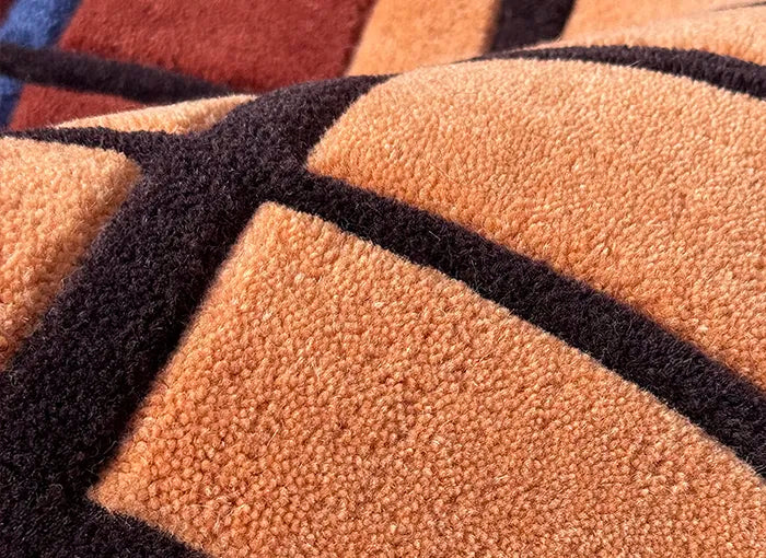 Close-up of a textured rug with geometric patterns in brown and black.