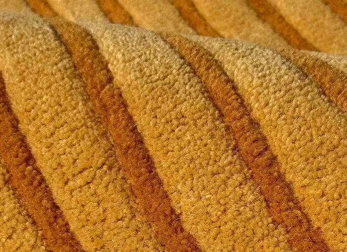 Close-up of a textured brown and beige carpet with diagonal stripes.