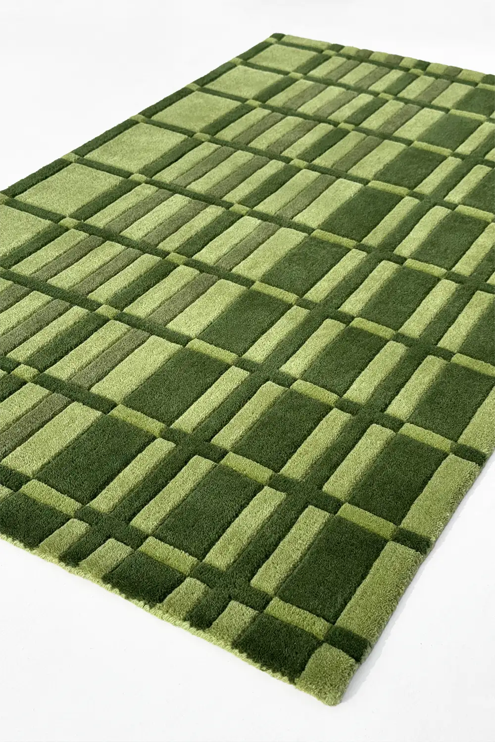 Green geometric striped checkered rug hand tufted from wool on a white background