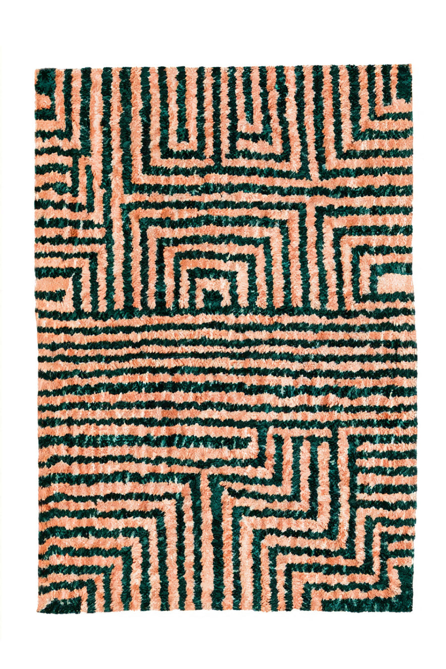 green and tan plush tufted rug with a maze design