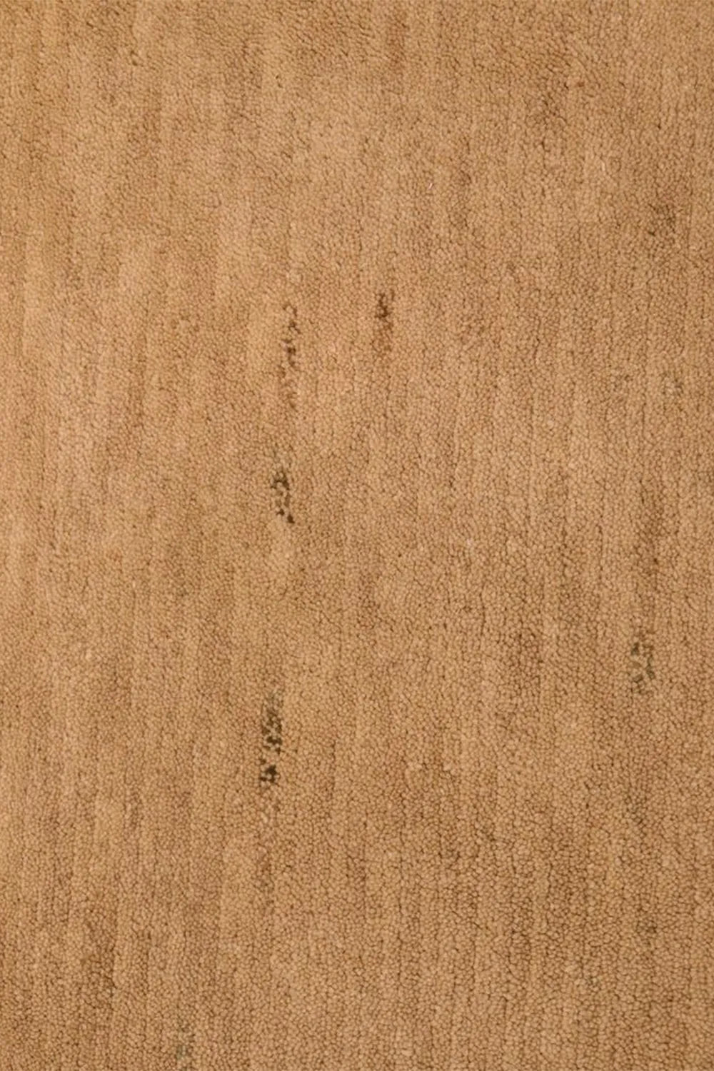 detail view of minimalist tan wool area rug, perfect for earthy living rooms and luxury bedrooms