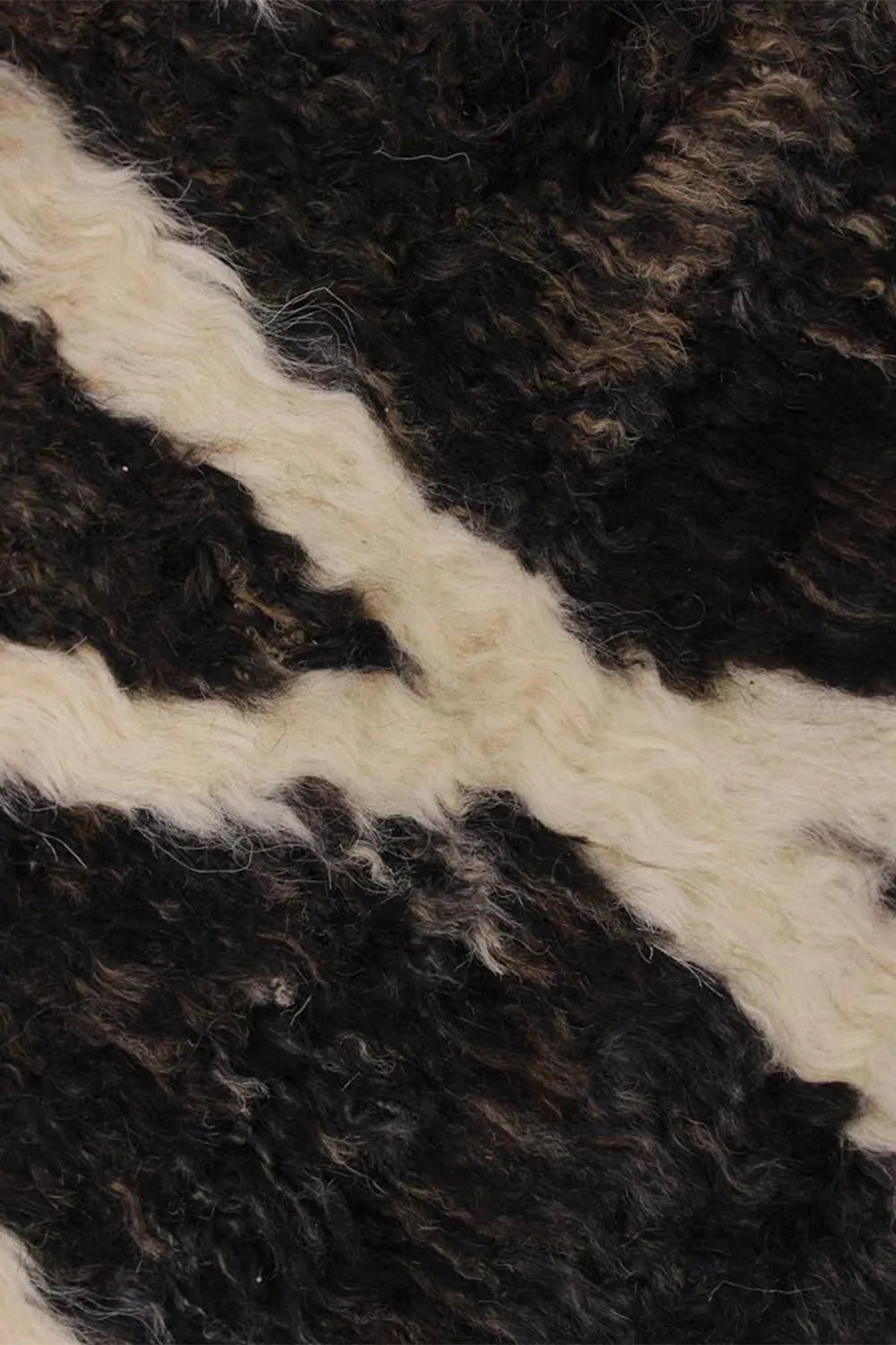 High pile area rug in black and white, adding a bold statement to any room.