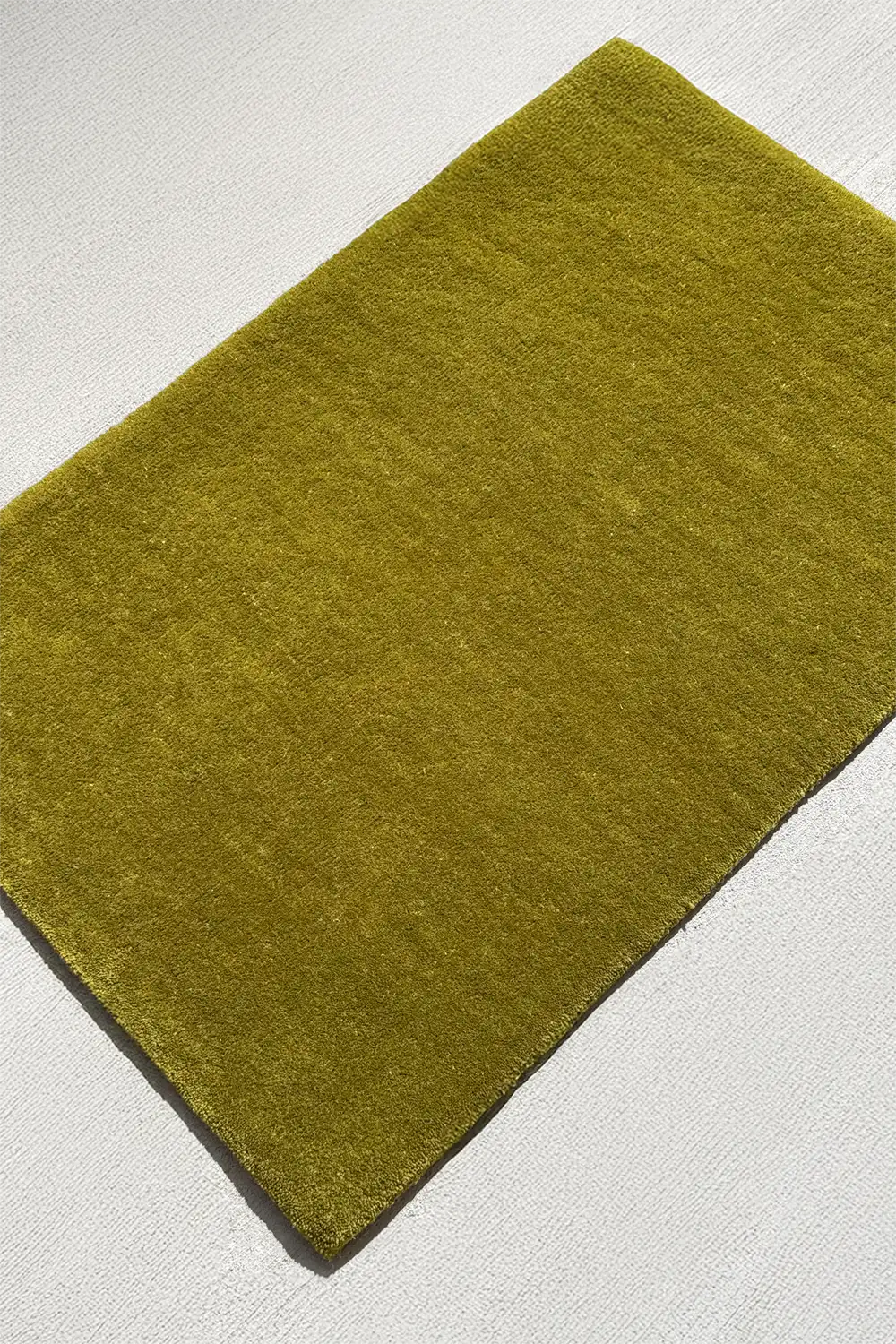 olive green 4x6 rectangular rug on a light gray background