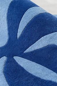 Abstract floral hand-tufted blue wool rug with curved forms, boutique 4x6 area rug for modern interiors