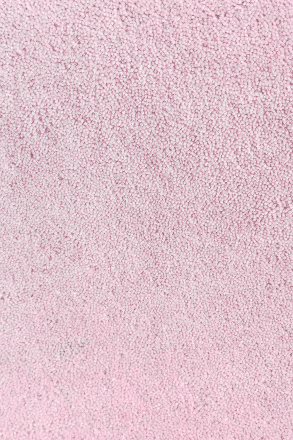 Close-up of thick blush light pink wool rug with plush hand-tufted pile, perfect for high-pile bedroom rugs or luxury nurseries