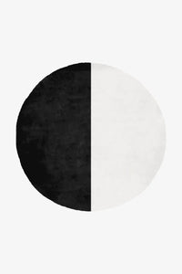 bold black and white round wool tufted rug for modern living rooms and high-end entryways
