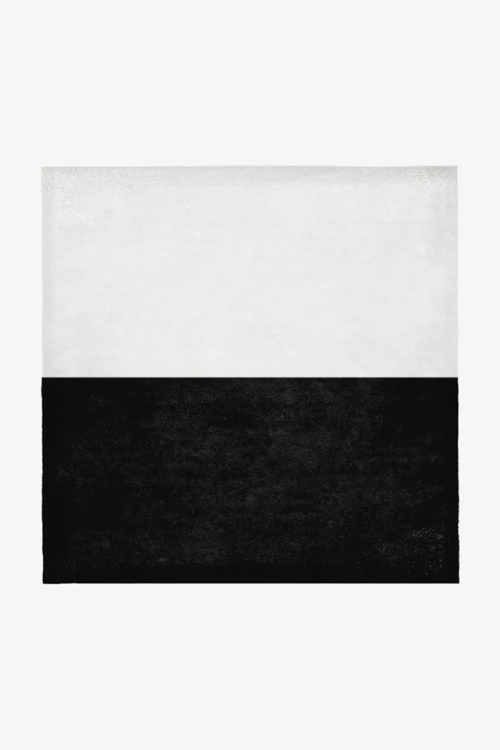 Crisp white and bold black wool square rug in 7x7 or 9x9 sizing, ideal for minimalist interiors, graphic modern homes, and high-contrast organic modern spaces.