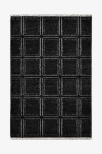 Black checkered wool rug with white lines on a white background