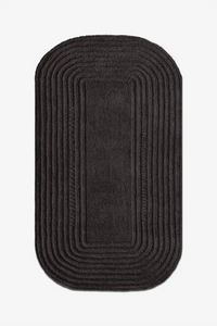 black oval wool rug textured japandi design
