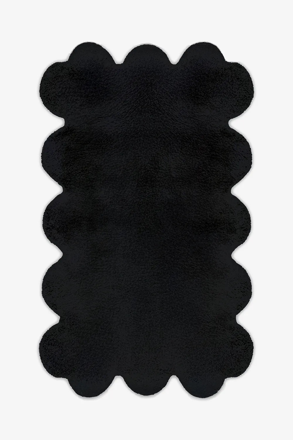 8x10 black scalloped wool rug with sculptural hand-tufted edges, perfect for modern minimalist living rooms