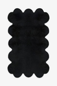 8x10 black scalloped wool rug with sculptural hand-tufted edges, perfect for modern minimalist living rooms