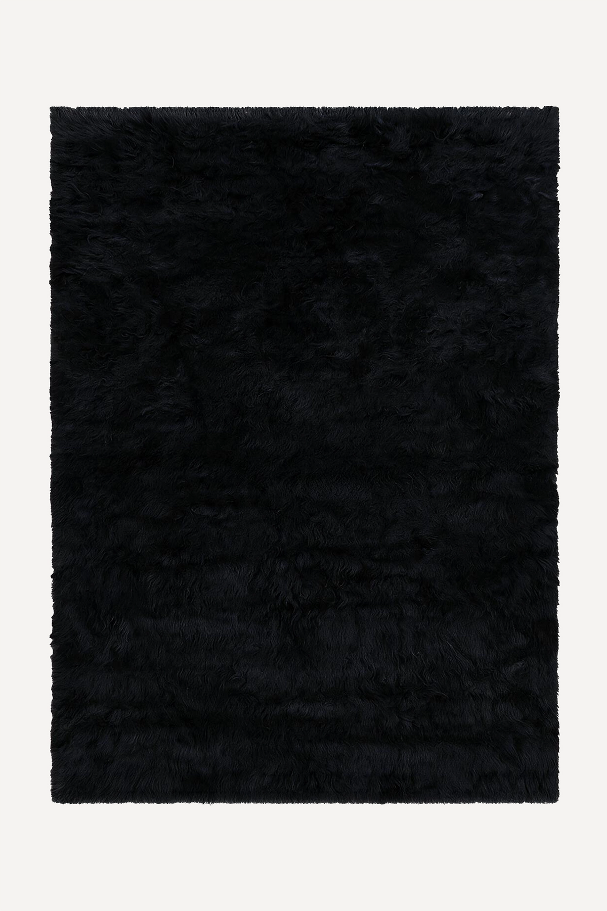 A rectangular black shaggy wool rug shown flat against a light off-white background.