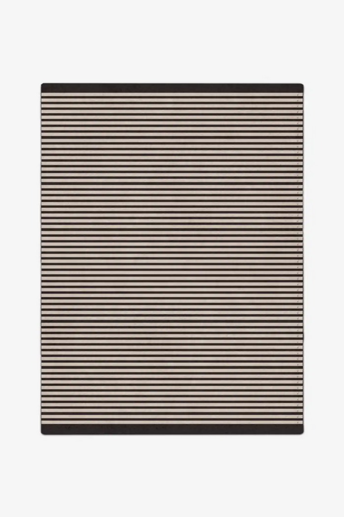 Striped wool rug with black and beige stripes on a white background