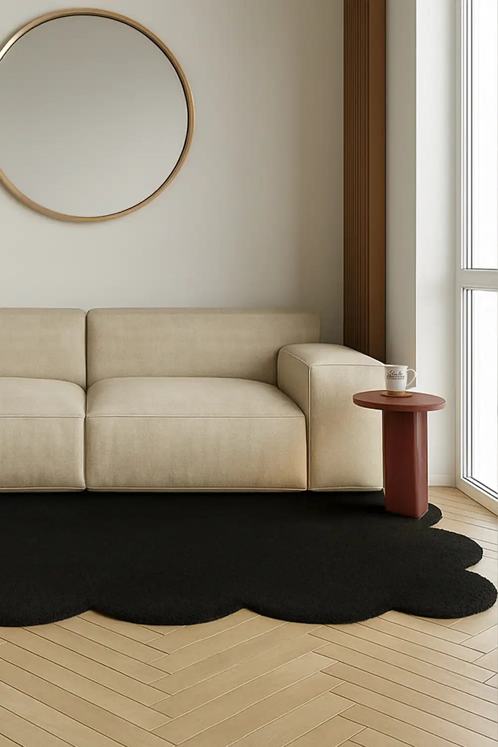 Modern black scalloped rug styled under neutral sofa on light wood floors, perfect for Japandi or boho interiors