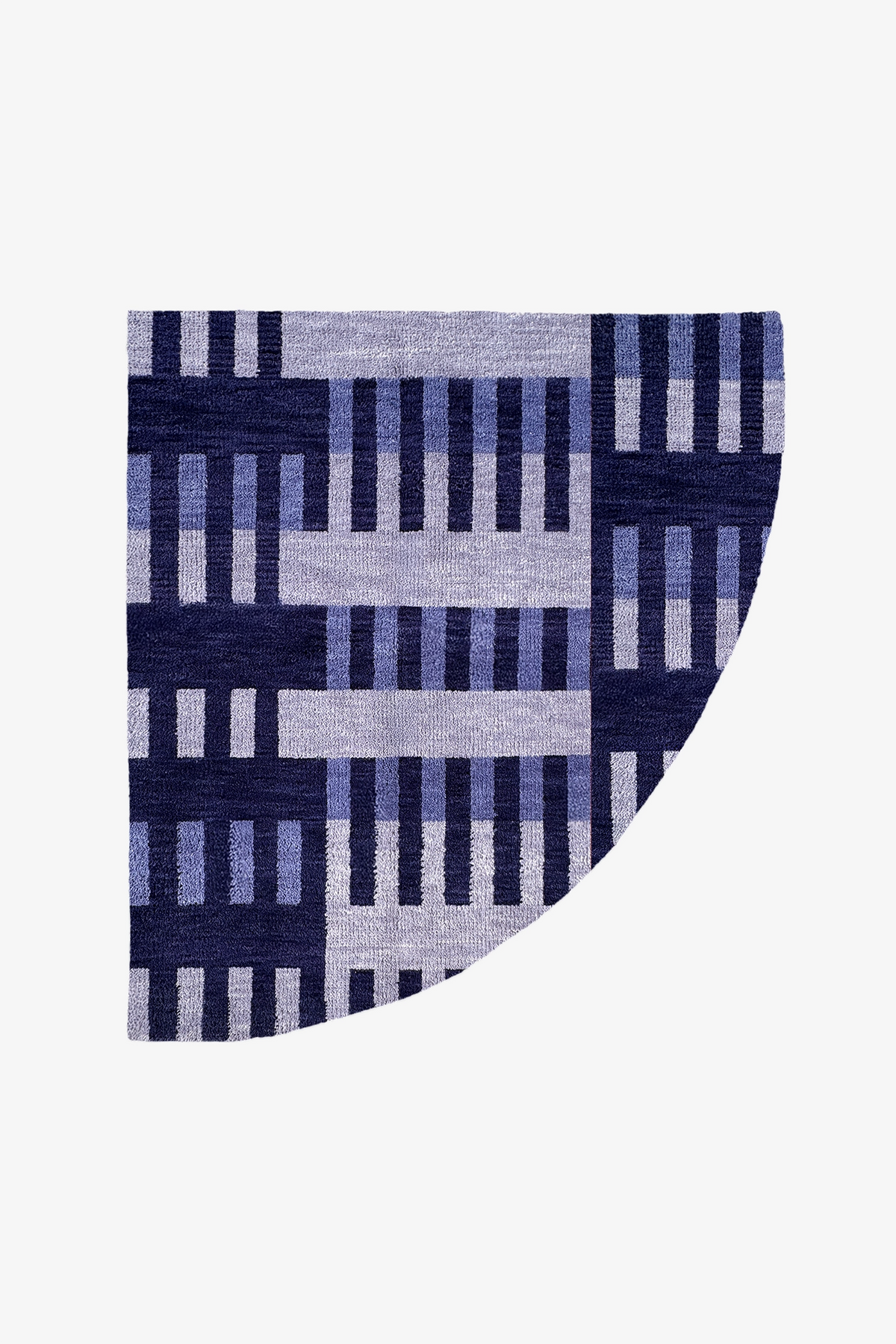 A quarter circle rug featuring a geometric woven pattern in navy blue, medium blue, and light gray on a plain white background.