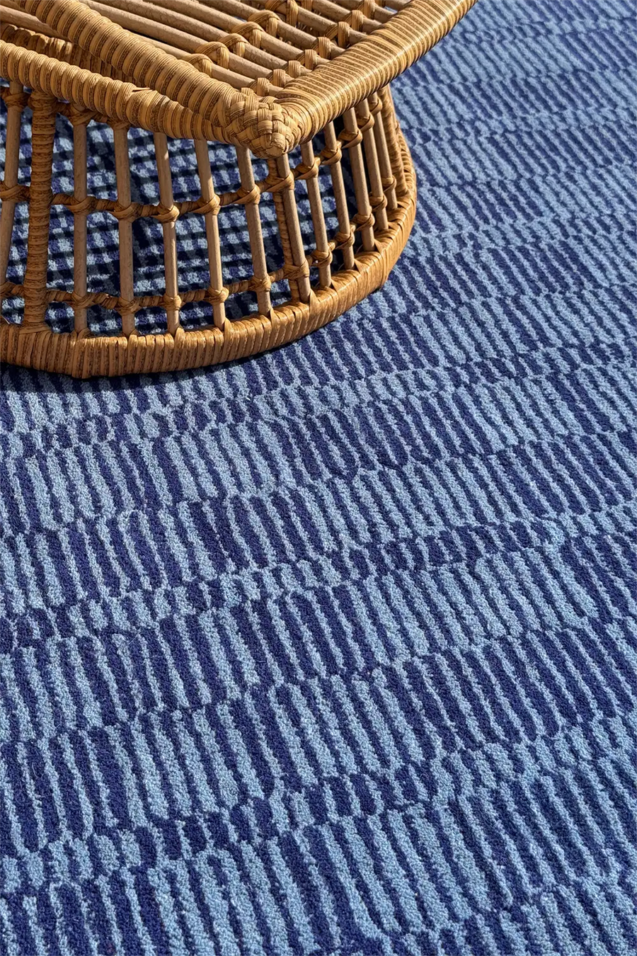 Dark blue and light blue stripe rug shown in styled home with boho furniture accents